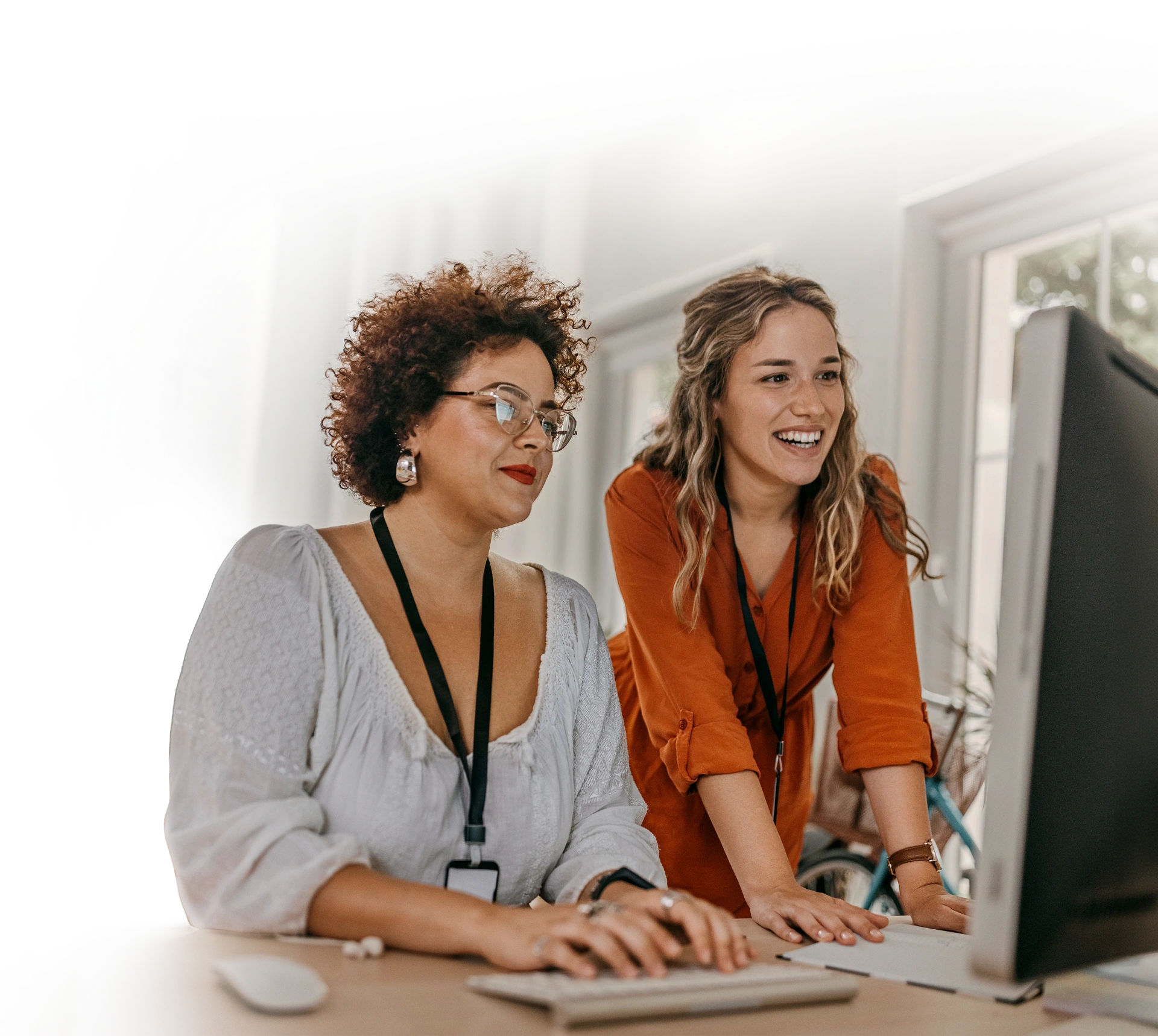 Two colleagues working together at a computer.